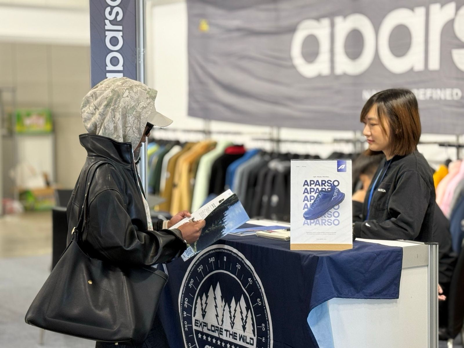 A buyer reading a supplier catalogue at a booth