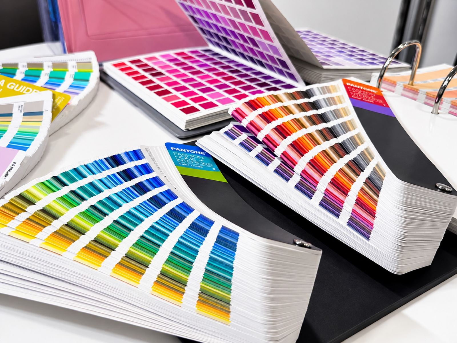 Pantone colour guides fanned out on a desk