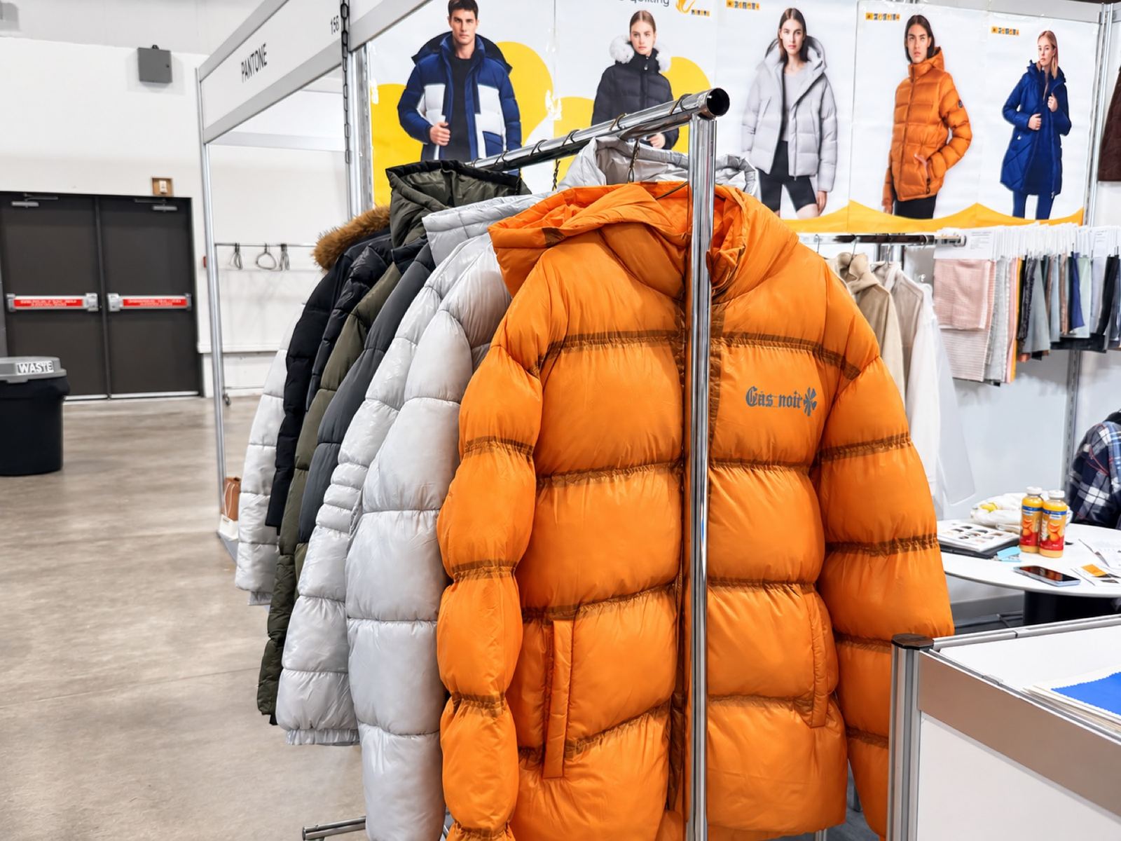 An orange puffer jacket in an outdoor showroom