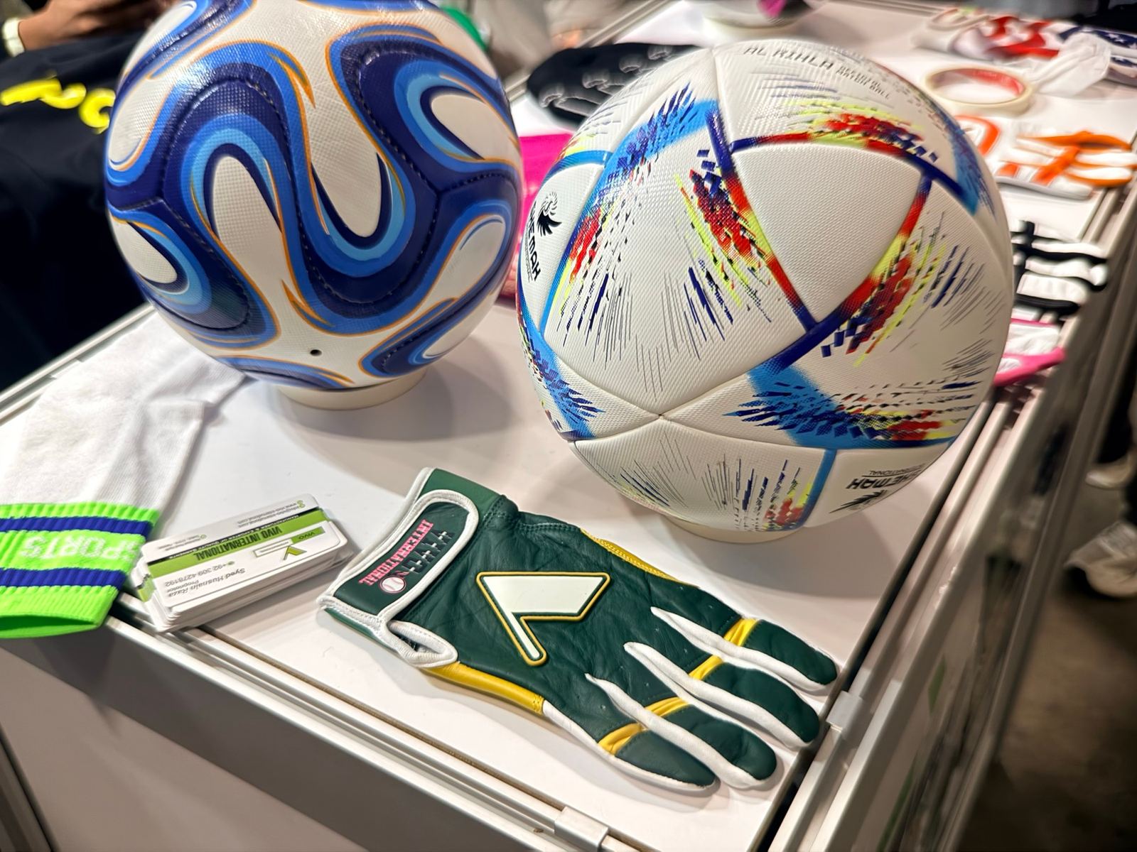 Footballs and sports gloves on a supplier table