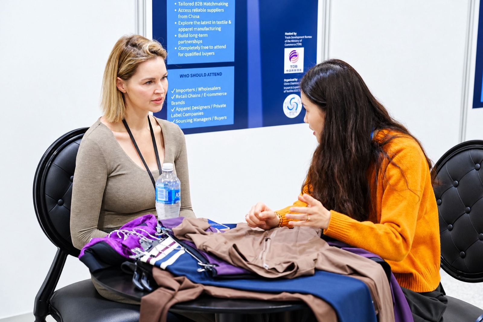 A buyer and a supplier reviewing fabric swatches